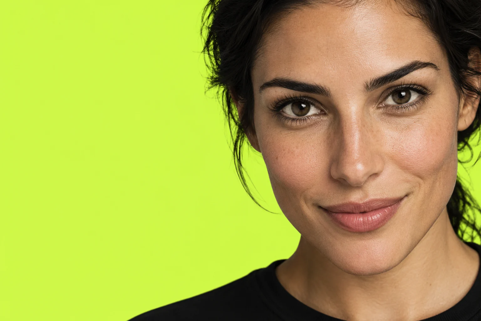 Close-up campaign portrait of a woman against an electric lime background